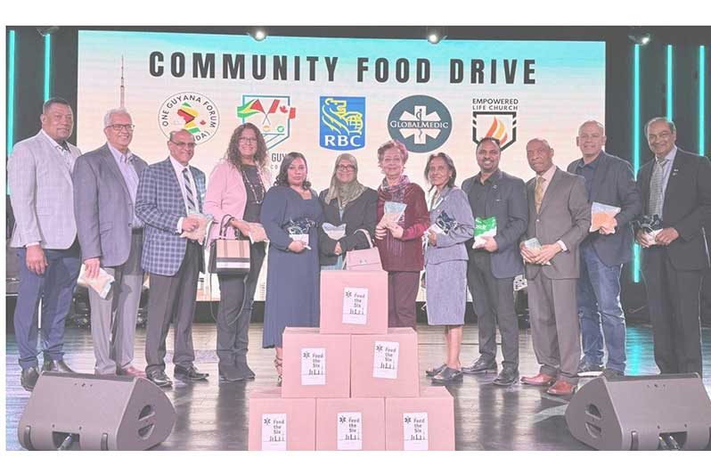 Supporters of the Community Food Drive deliver boxes of food to the Empowered Life Church, one of many religious organisations in Toronto that helped distribute food hampers to the poor (Second from left, Winston Kassim; sixth from left, Bibi Shariman Ali; seventh from left, Kameni Kassim; far right, Jerry Karamat)