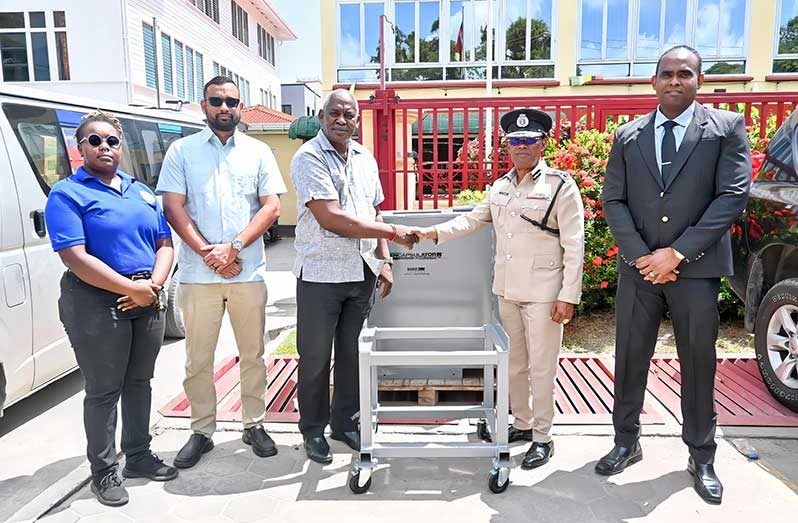 Minister of Home Affairs Robeson Benn officially handed over the Bullet Trap to the Commissioner of Police (ag), Clifton Hicken, while being flanked by Permanent Secretary, Andre Ally and Deputy Commissioner ‘Law Enforcement’, Wendell Blanhum and another official during a ceremony at the Ministry of Home Affairs