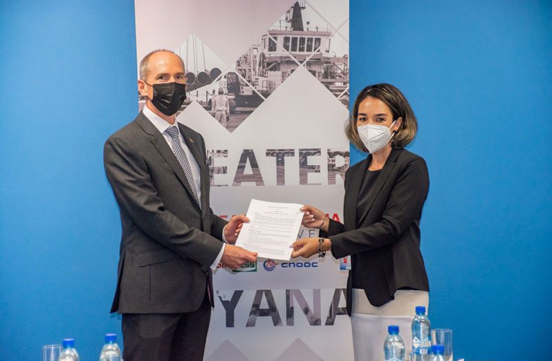 ExxonMobil Guyana’s President, Alistair Routledge and The Consultancy Group’s Cladia Van Sluytman sign the MOU for the poultry project in Region Nine