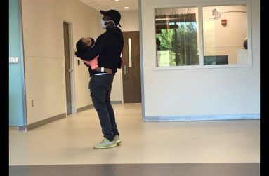 A dedicated, hands-on father with his sick young daughter, waiting to see the doctor at the hospital (Photo by Francis Quamina Farrier)
