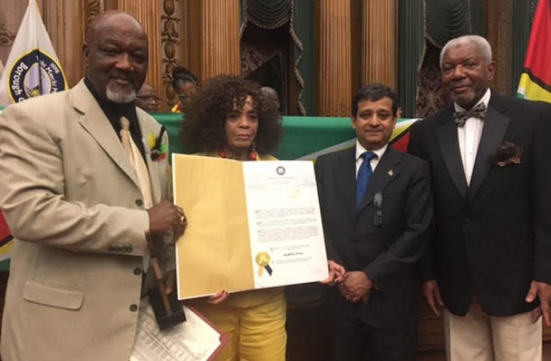 Displaying the Brooklyn Borough President Citation to 
Godfrey Wray are, from left, Journalist Dennis A. Nelson, Patricia 
Jordon-Langford, Ambassador Riyad Insanally and Ronald Lammy. 