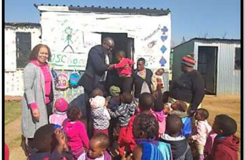 Guyana Ambassador to South Africa, Kenrick Hunte and his wife, Mrs Clair Hunte interacting with children of Soweto (File photo)