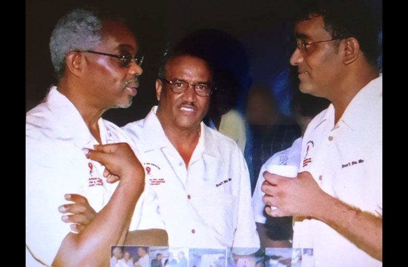 Dr. Fenton Sands (left) making a point to then President Bharrat Jagdeo as American Ambassador Roland Bullen looks on