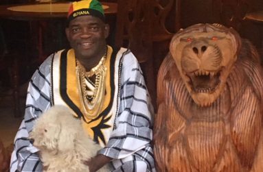 Manager Hugh October poses with the carved wooden lion at the entrance of the Regent Street Creole 'N' Bar-Be