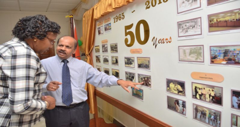 Minister in the Ministry of Public Infrastructure, Annette Ferguson being given a brief on the history of the Bank of Guyana at the launch of the financial institution’s 50th
Anniversary stamp on Wednesday (Delano Williams photo)