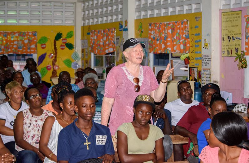 A resident poses a question to Minister of
State Joseph Harmon during the ministerial
outreach at Den Amstel Primary School,
West Coast Demerara on Sunday (Samuel
Maughn photo)