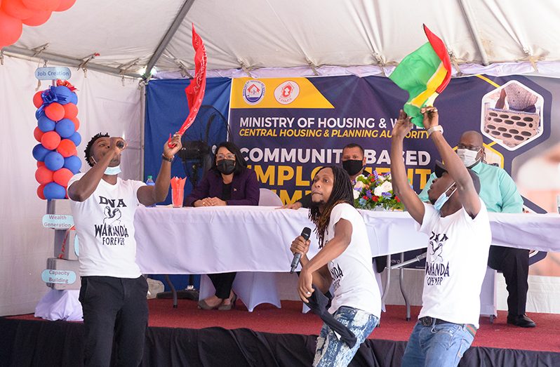 Artistes performing at the launch of the $20M Community-based Employment Stimulation Project (CESP) in Tiger Bay by the Ministry of Housing and Water on Monday. Looking on from the head table as the drama unfolds are, from left, Housing and Water Ministers Susan Rodrigues and Collin Croal, and Central Housing and Planning Authority Chief Executive Officer, Sherwyn Greaves (Delano Williams photo)