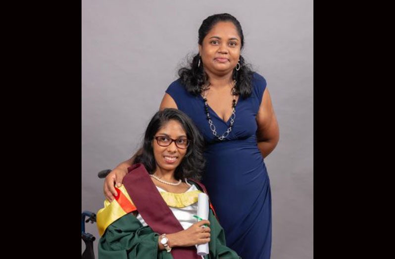 Rajni Persaud thanks her parents for being her main support in achieving academic success. In photo the graduand poses with her proud mother (UG photo)