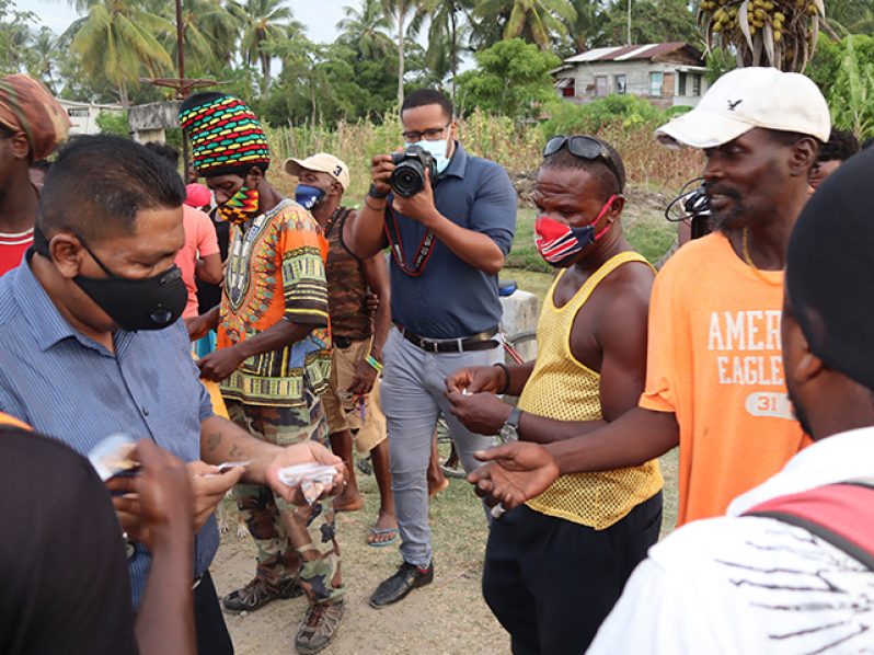 Agriculture Minister, Zulfikar Mustapha, distributing a number of seeds to farmers during his visit to Buxton, East Coast Demerara, on Tuesday