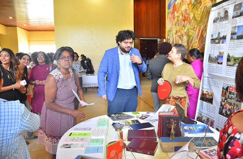 United Nations peace and development officer Srdan Deric interacts with participants at a booth during the opening of Inter-faith Harmony Week at the National Cultural Centre on Thursday (Samuel Maughn photo)