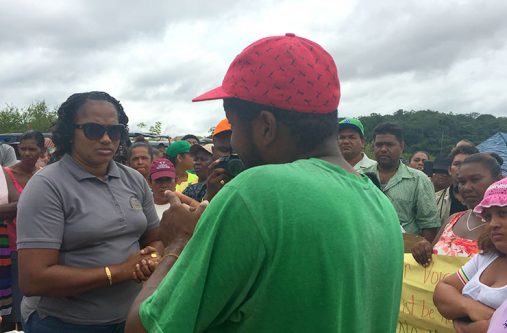 Minister within the Ministry of Public Infrastructure, Annette Ferguson,
(left) listens to the concerns of a bus driver as other residents from
Coomacka, Region 10, look on. (MPI photo)