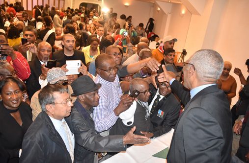 front-pic-(2) President David Granger interacting with members of the Guyanese diaspora in London who turned out in their numbers to meet with him on Thursday
(Ministry of the Presidency photo)