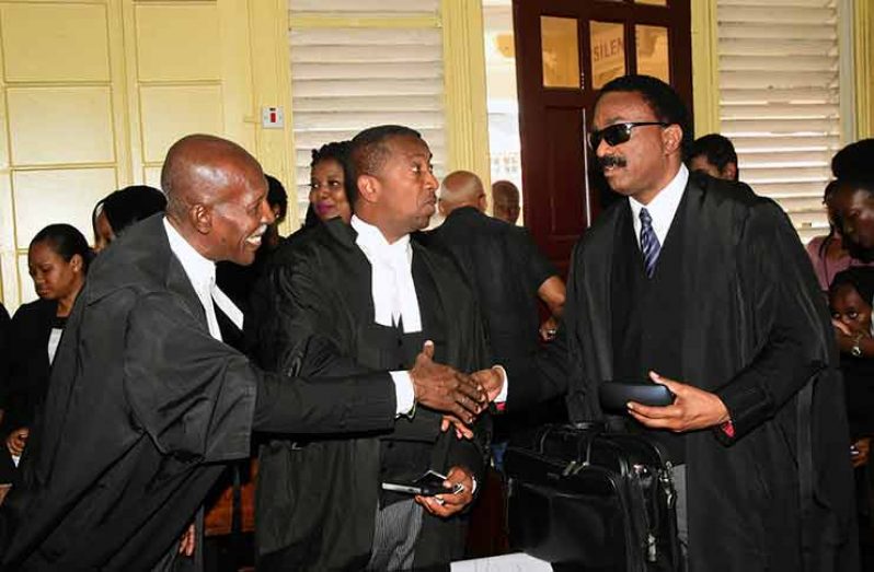 Congratulations! Barbadian Queens Counsel Hal Gollop (left) and Ralph Thorne (center) exchange pleasantries with crackdown
Attorney General Basil Williams (right) Friday after Chief Justice Roxane George-Wiltshire handed down her ruling.
(Adrian Narine photo )