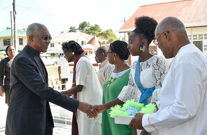 President David Granger (left) greets a young
member of the Arundel Congregational Church in
Buxton Sunday afternoon. The church celebrated its
175th Anniversary (Ministry of the Presidency photo)