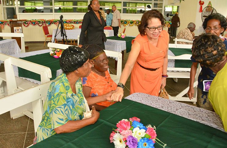First Lady Mrs. Sandra Granger on Tuesday joined the students and teachers of the President’s College at their Annual Christmas Party for Senior Citizens at the Golden Grove, East Coast Demerara location. In picture, The First Lady shakes hands with Ms. Ingrid Neil of Haslington, ECD (first left) even as she greets another guest at the party (MoTP photo)