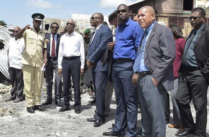 Director of Prisons, Mr. Gladwin Samuels, points to a section of the gutted Camp St Prison as President David Granger
and other Cabinet members look on. In photo are: AG, Basil Williams, Minister of State, Joseph Harmon, Minister of Public
Infrastructure, David Patterson, Minister of Social Cohesion, Dr George Norton and Minister of Public Security, Khemraj
Ramjattan (Ministry of the Presidency photo)