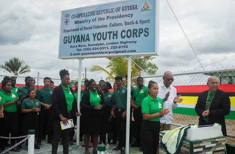President David Granger, students and other officials applaud as the veil is lifted from the plaque signalling the opening
of the Guyana Youth Corps, located at Kuru Kuru on the Soesdyke-Linden Highway (Delano Williams photo)