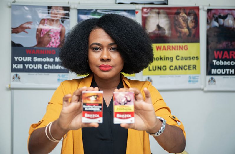 Ministry of Public Health Legal Adviser on Tobacco Control, Kesaundra
Alves, displays some of the samples of modified cigarette packages
(Samuel Maughn photo)