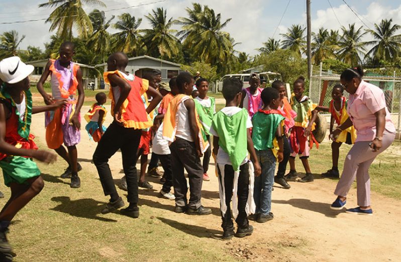Minister within the Ministry of Natural Resources, Simona Broomes shows off her dancing skills in the presence of young
masqueraders from Ann’s Grove during an engagement in the East Coast Demerara community on Saturday (Adrian Narine photo)