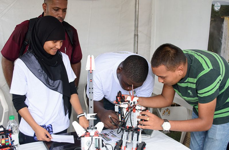 Members of STEM Guyana-the national team that will represent this country at the
inaugural Robot Olympics in Washington, DC July showcasing how they build a
robot at the launch of the Youth Innovation Project Guyana in commemoration of
National Youth Week 2017 (Samuel Maughn photo)
