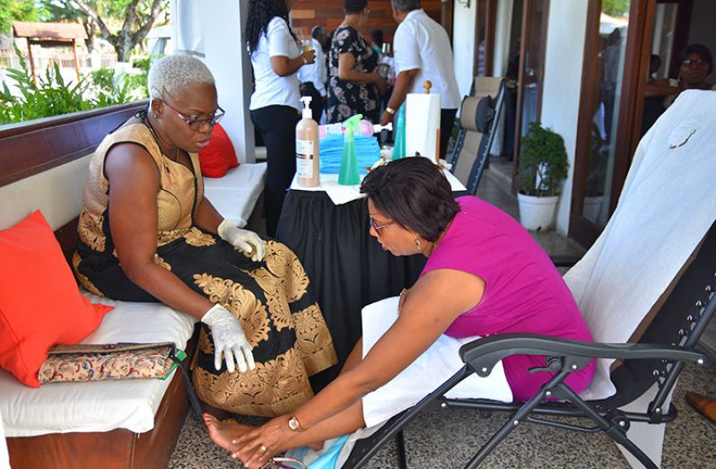 Minister of Public Telecommunications, Catherine Hughes consults with Yvonne Brathwaite, owner of Trinidad-based Rovon Home
Health Care Incorporated, which on Sunday launched its podology service in Guyana (Samuel Maughn photo)