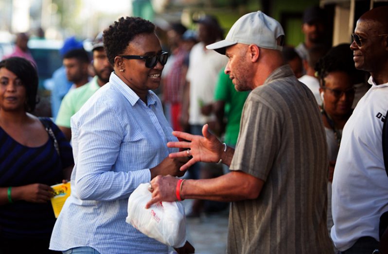 Minister within the Ministry of Public Infrastructure, Annette Ferguson engages a city resident during a ministerial outreach in
the Bourda, Georgetown area on Friday (Adrian Narine photo)