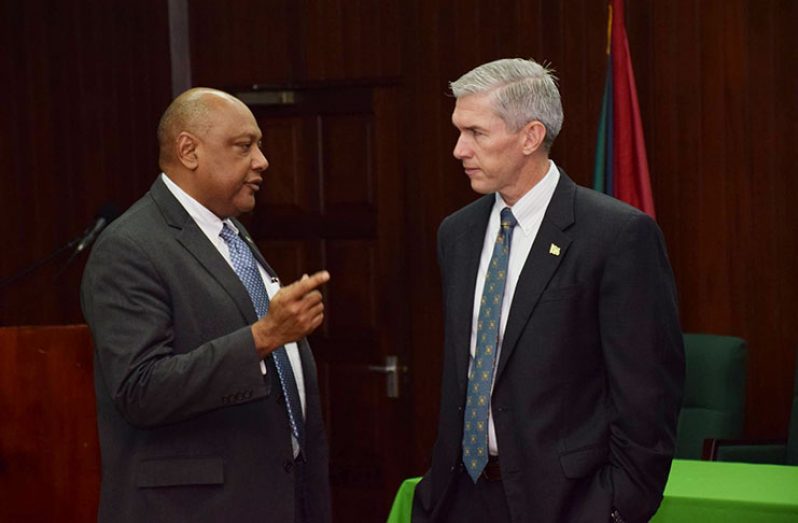 Minister of Natural Resources, Raphael Trotman and ExxonMobil Country Manager Rod Henson locked in discussion
during the stakeholders’ forum at the Ministry of the Presidency on Thursday to release the contract between the company
and the Guyana Government (DPI photo)