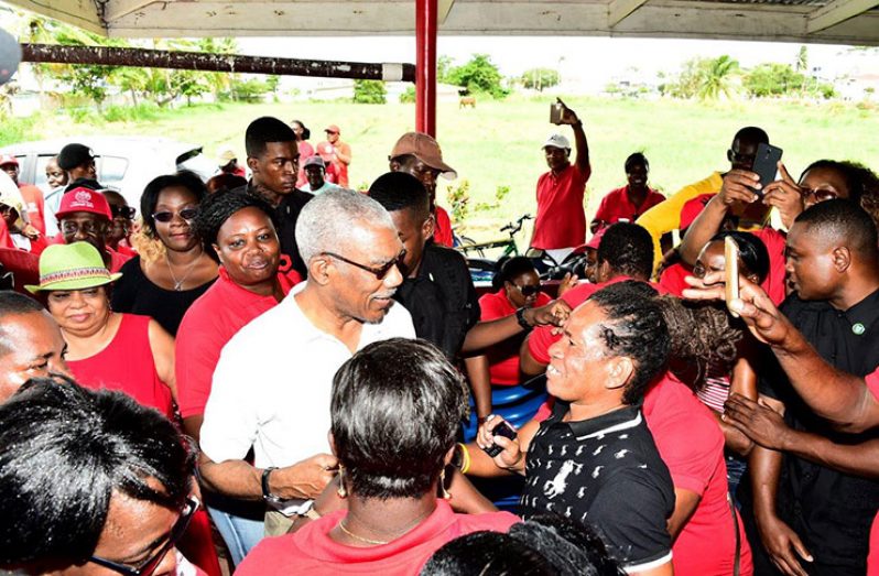 President David Granger surrounded by
members of the Local Government Officers
Union during one of his many stops as part of
his Labour Day activities
