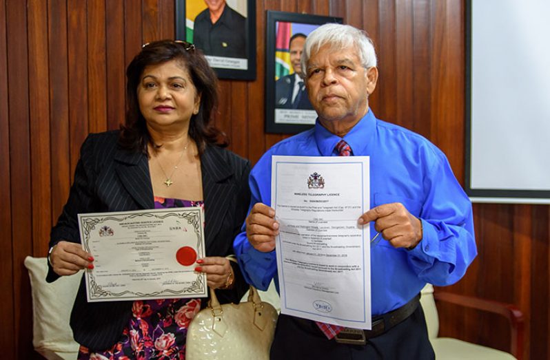 CN Sharma and Mrs Savitri Sharma proudly display their radio and Wireless Telegraphy Licences following a ceremony at the
Guyana National Broadcasting Authority headquarters on Friday (Samuel Maughn photo)