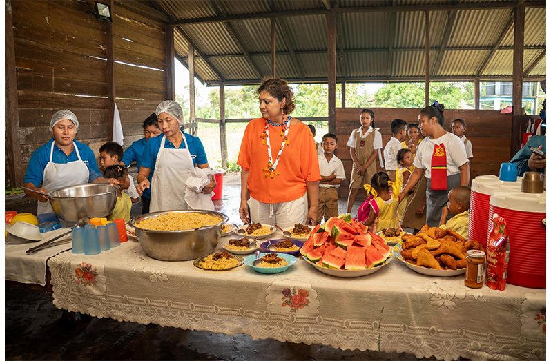 On Wednesday, Minister of Education Priya Manickchand commissioned the Para Bara Nursery School and a new duplex teachers’ accommodation. Prior to this, the nursery children were housed in a corner of the primary school. This new school gives both the primary and nursery children child- friendly learning spaces, and this was welcomed by the community. A young teacher from the village of Awarenau is already occupying one of the teachers’ homes, thereby allowing a stronger delivery of education in the village. Minister Manickchand was particularly pleased that the library, under the “Libraries for Primaries Programme” had already reached the deep-south village, and expressed delight and satisfaction that all the teachers were in training or about to begin training while being able to stay in the Village. The Minister had a lunch of peas-and-rice with stewed chicken, and watermelon and swank with the children during their hot-meal provision (MoE photos)