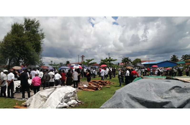 Persons pay their last respects to Komal Chand at the West Coast Demerara cremation site