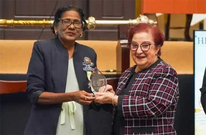 Minister of Parliamentary Affairs and Governance, Gail Teixeira, MP, receiving the prestigious Commonwealth Lifetime Achievement Award from Confidential Secretary to the Speaker of the National Assembly, Jaitun Haniff