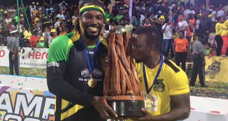 Jamaica Tallawahs captain Chris Gayle celebrates with the CPL trophy after trouncing the Warriors in the final  at Warner Park last night.