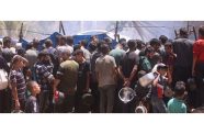People gather at a food distribution site in Gaza (UN News photo)