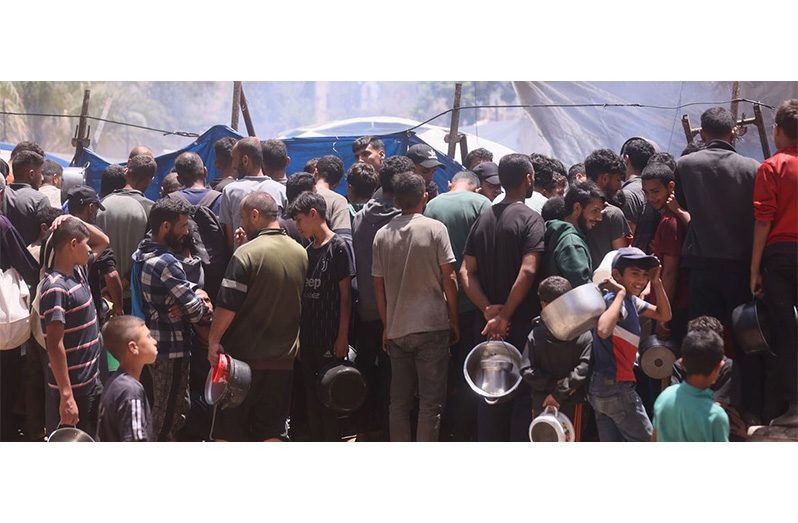 People gather at a food distribution site in Gaza (UN News photo)