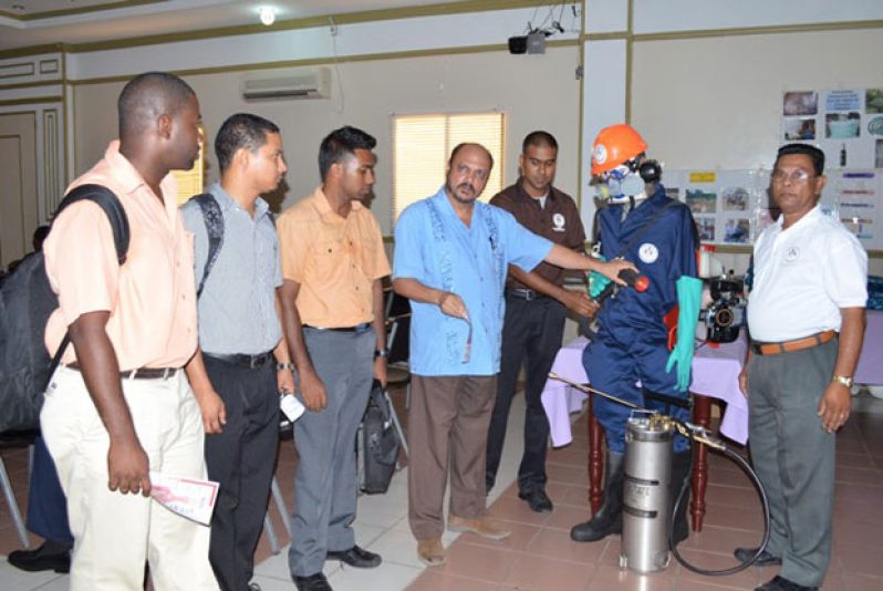 Health Minister Dr. Bheri Ramsaran (4th from left) examining protective gear for Vector Control Services staff