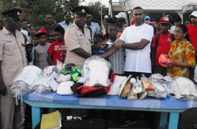 Former cop Bobby Kewlochand makes the presentation of sport equipment to Assistant Superintendent of Police Guy Nurse.