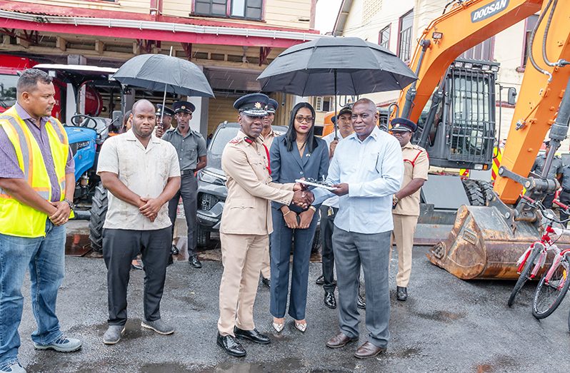 Minister of Home Affairs, Robeson Benn, hands over the keys to the vehicles to the Fire Chief (ag), Gregory Wickham