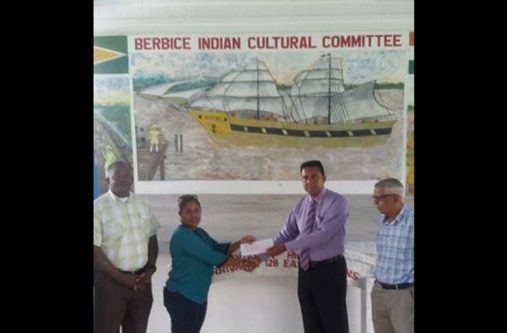 gift Berbice Indian Cultural Committee President,Chandra Sohan receives the cheque from National Trust of Guyana Chief Executive Officer(CEO),Nirvana Persaud