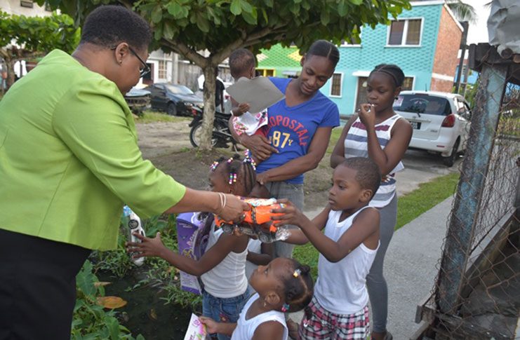 Minister Lawrence presents gifts to these Laing Avenue children (DPI photo)
