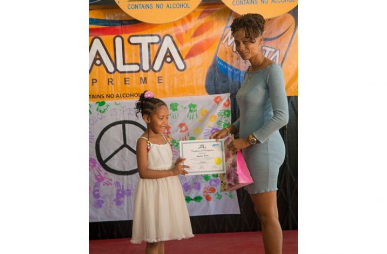 A summer camp participant receiving her certificate (DPI photo)