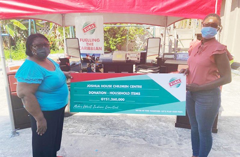 (L-R) Gladys Accra of Joshua House at the presentation of items with Joylyn Johnson of RUBIS.