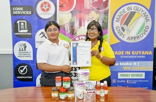 Owner and CEO of B&R Products, Budwatty Ramnarine and her daughter Adelia Ramnarine proudly display the GNBS approved ‘Made in Guyana’ certificate, alongside the certified products