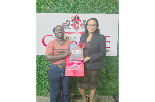 Shaniece Williams receives her prize from the Marketing and Circulation Manager of the GNNL, Beverly Roberts