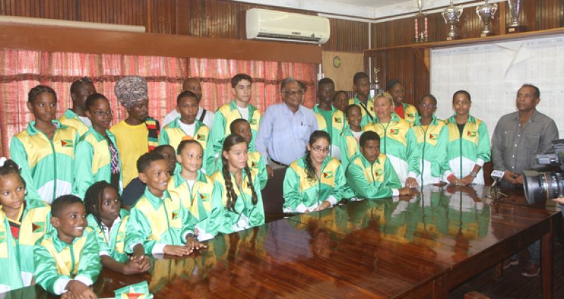 Director of Sport, Neil Kumar, poses with swimmers yesterday in the NSC Boardroom, to  extreme right is GASA president, Ivan Persaud.