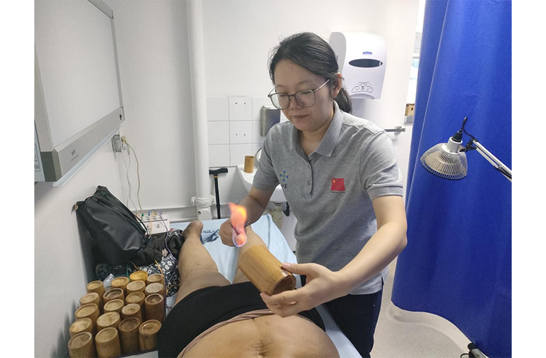 Dr.Wei Jie performs cupping therapy for a local patient with lumbar disc herniation at the Georgetown Public Hospital Corporation’s TCM Clinic