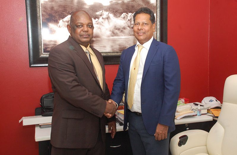 Outgoing GPL Chairman Robert Badal (right) shakes hands with New GPL Chief Executive Officer, Albert Gordon (GPL photo)