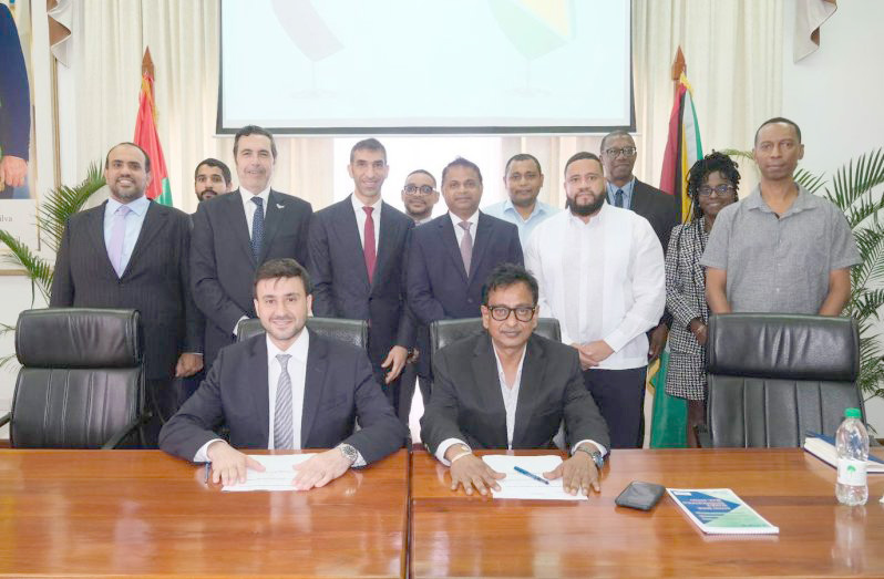 Head of GPL's Executive Management Committee, Kesh Nandlall, (seated, right) and Chief Executive Officer of Global South Utilities, Ali Abdulla Ali Mohammed Alshimmari (seated, left) and other officials following the signing of a strategic Memorandum of Understanding (MoU) which will help to transform Guyana’s electricity sector (GPL photo)