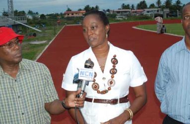 Jamaica’s three-time Olympian Grace Jackson (centre) fields questions from the media yesterday at the synthetic track after having a first hand look of the facility. Others in this Cullen Bess-Nelson photo are Steve Ninvalle  DPS MCY&S (left) and Permanent Secretary Alfred King.