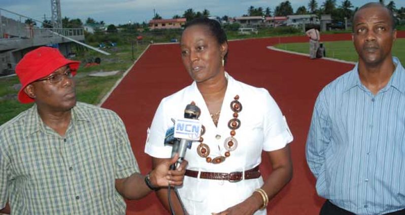 Jamaica’s three-time Olympian Grace Jackson (centre) fields questions from the media yesterday at the synthetic track after having a first hand look of the facility. Others in this Cullen Bess-Nelson photo are Steve Ninvalle  DPS MCY&S (left) and Permanent Secretary Alfred King.